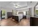 Serene main bedroom with a tray ceiling, hardwood floors, and plenty of natural light at 8921 Walking Stick Trl, Raleigh, NC 27615