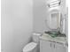 Modern powder room with a unique vessel sink and updated lighting at 8921 Walking Stick Trl, Raleigh, NC 27615