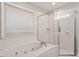 Bathroom with a tub featuring jets and a glass-enclosed shower at 903 Norwood Lane Ln, Apex, NC 27502