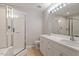 Bright bathroom featuring double sinks, a tub, and a glass-enclosed shower at 903 Norwood Lane Ln, Apex, NC 27502