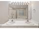 Bathroom featuring double sinks, ample lighting, and a tub/shower at 903 Norwood Lane Ln, Apex, NC 27502