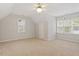 Spacious bedroom with a ceiling fan, large windows, and neutral carpet at 903 Norwood Lane Ln, Apex, NC 27502