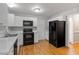 Kitchen with white cabinets, black appliances, and light countertops at 903 Norwood Lane Ln, Apex, NC 27502