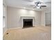 Bright living room with carpet, a ceiling fan, fireplace, and ample natural light at 903 Norwood Lane Ln, Apex, NC 27502