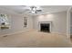 Bright living room with carpet, a fireplace, and multiple windows allowing in natural light at 903 Norwood Lane Ln, Apex, NC 27502