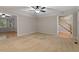 Open living room with carpet, fan, and views into the entryway and other spaces at 903 Norwood Lane Ln, Apex, NC 27502