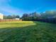 Large backyard featuring lush green grass and wood fencing at 91 Paige Stone Way, Angier, NC 27501