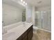 Bright bathroom with a double sink vanity, large mirror and stand up shower at 91 Paige Stone Way, Angier, NC 27501