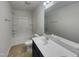 Bright bathroom featuring a double sink vanity, toilet, and shower/tub combo at 91 Paige Stone Way, Angier, NC 27501