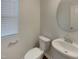 This half-bath features modern fixtures, including a toilet and pedestal sink at 91 Paige Stone Way, Angier, NC 27501