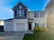 Two-story home with a two-car garage, neutral siding, black shutters, and a well-maintained lawn at 91 Paige Stone Way, Angier, NC 27501