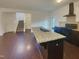 Open kitchen with granite island, modern appliances, seamlessly connecting to living spaces at 91 Paige Stone Way, Angier, NC 27501