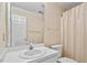 Traditional bathroom with single sink vanity, patterned wallpaper, and shower with neutral curtain at 9204 Cub Trl, Raleigh, NC 27615