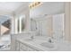 Bright bathroom featuring double sink vanity, lots of natural light, and glass-enclosed shower at 9204 Cub Trl, Raleigh, NC 27615