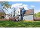 Exterior view of the home from the backyard, featuring a deck, grill, and lush lawn at 9204 Cub Trl, Raleigh, NC 27615