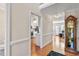 Hallway featuring hardwood floors that lead to the kitchen and other rooms in the house at 9204 Cub Trl, Raleigh, NC 27615