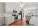 Bright kitchen with stainless steel appliances, white cabinets, and hardwood floors at 9204 Cub Trl, Raleigh, NC 27615