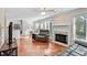 Spacious living room with hardwood floors, a fireplace, and seamless access to the kitchen and breakfast nook at 9204 Cub Trl, Raleigh, NC 27615