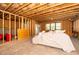 Unfinished basement with exposed beams and a walk-out door leading to the outside at 936 Regency Cottage Pl, Cary, NC 27518