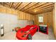 Unfinished basement with exposed beams and a fun race car bed at 936 Regency Cottage Pl, Cary, NC 27518