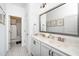 Bathroom with dual sinks, framed mirrors, and tile flooring in a modern design at 936 Regency Cottage Pl, Cary, NC 27518
