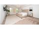 A grand bedroom features a chandelier, a large bed, mirrors, and plush carpeting at 936 Regency Cottage Pl, Cary, NC 27518