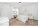 Comfortable bedroom with a white bed, matching nightstands, and a charming window view at 936 Regency Cottage Pl, Cary, NC 27518