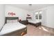 Bright bedroom featuring two twin beds, soft carpet, and vibrant decorations at 936 Regency Cottage Pl, Cary, NC 27518