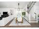 Dining room with glass table set, modern chandelier, and open staircase at 936 Regency Cottage Pl, Cary, NC 27518
