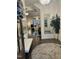 Bright entryway featuring a decorative rug, mirror, bench seating, and a glimpse of the living area at 936 Regency Cottage Pl, Cary, NC 27518
