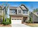 Beautiful home with stone and siding, complemented by a well-maintained lawn and a convenient two-car garage at 936 Regency Cottage Pl, Cary, NC 27518