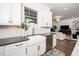Bright kitchen showcases stainless appliances, shaker cabinets, subway tile backsplash, and a farm style sink at 936 Regency Cottage Pl, Cary, NC 27518