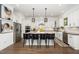 Bright kitchen features stainless appliances, shaker cabinets, pendant lights, and a large island with seating at 936 Regency Cottage Pl, Cary, NC 27518