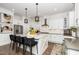 Bright kitchen features stainless appliances, shaker cabinets, pendant lights, and a large island with seating at 936 Regency Cottage Pl, Cary, NC 27518