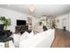 Bright living room featuring a chandelier, hardwood floors, and elegant decor at 936 Regency Cottage Pl, Cary, NC 27518
