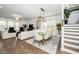 Open living room features large windows, hard wood floors and elegant furniture with lots of seating at 936 Regency Cottage Pl, Cary, NC 27518