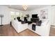 Bright living room featuring a chandelier, hardwood floors, and elegant decor at 936 Regency Cottage Pl, Cary, NC 27518