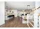 Open-concept living area with hardwood floors, stylish furnishings, and a clear view of the kitchen at 936 Regency Cottage Pl, Cary, NC 27518