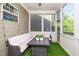 Cozy screened patio with seating, ceiling fan, and an outdoor view at 936 Regency Cottage Pl, Cary, NC 27518