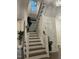 Elegant staircase featuring wooden treads, white risers, and a decorative painting at 936 Regency Cottage Pl, Cary, NC 27518