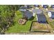 A backyard features a circular patio, fire pit, seating area, and lush landscaping; a virtual renovation at 95 Shady Creek Trl, Garner, NC 27529