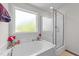 Bathroom with soaking tub, shower, decor, large window and natural light at 95 Shady Creek Trl, Garner, NC 27529