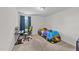Comfortable bedroom with twin bed, desk, chair, carpet, and natural light at 95 Shady Creek Trl, Garner, NC 27529