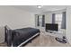 Bedroom with plush queen bed, carpet, natural light, and mounted tv at 95 Shady Creek Trl, Garner, NC 27529