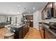 A kitchen boasts a central island with barstool seating and sleek, modern appliances on wood-look floors at 95 Shady Creek Trl, Garner, NC 27529