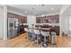 A kitchen boasts a central island with barstool seating and sleek, modern appliances on wood-look floors at 95 Shady Creek Trl, Garner, NC 27529