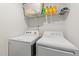 Bright laundry area with white washer, dryer, and wire shelving at 95 Shady Creek Trl, Garner, NC 27529