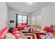 A living room with a red sofa, a glass coffee table, and lots of bright light at 95 Shady Creek Trl, Garner, NC 27529