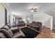 A living room features leather reclining sofas, a plush black rug, and wood-look floors at 95 Shady Creek Trl, Garner, NC 27529