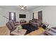 A living room features leather reclining sofas, a plush black rug, and wood-look floors at 95 Shady Creek Trl, Garner, NC 27529